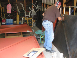 Joseph Vella painting the mural doors.